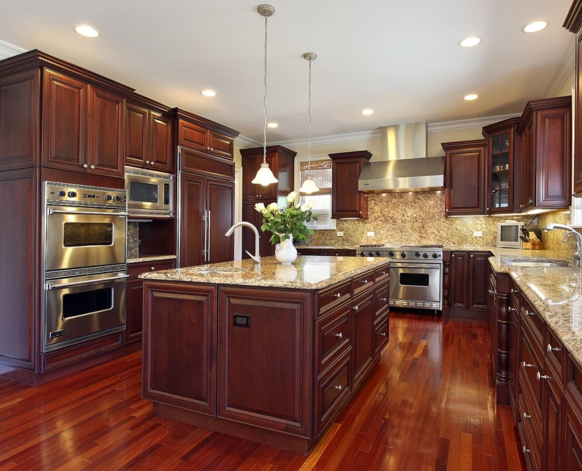 Kitchen in luxury home with cherry wood cabinets by Nest Inc. 